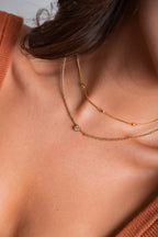 Collar Emilia con mostacillas doradas y punto de luz central – María Larraín